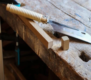 Cross Cut Saw and chopped wood on a wooden worktop bench